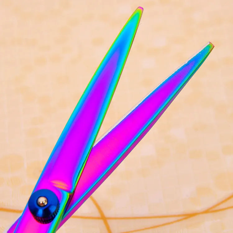 Three pet grooming scissors with purple handles on white background including curved flat and tooth shears