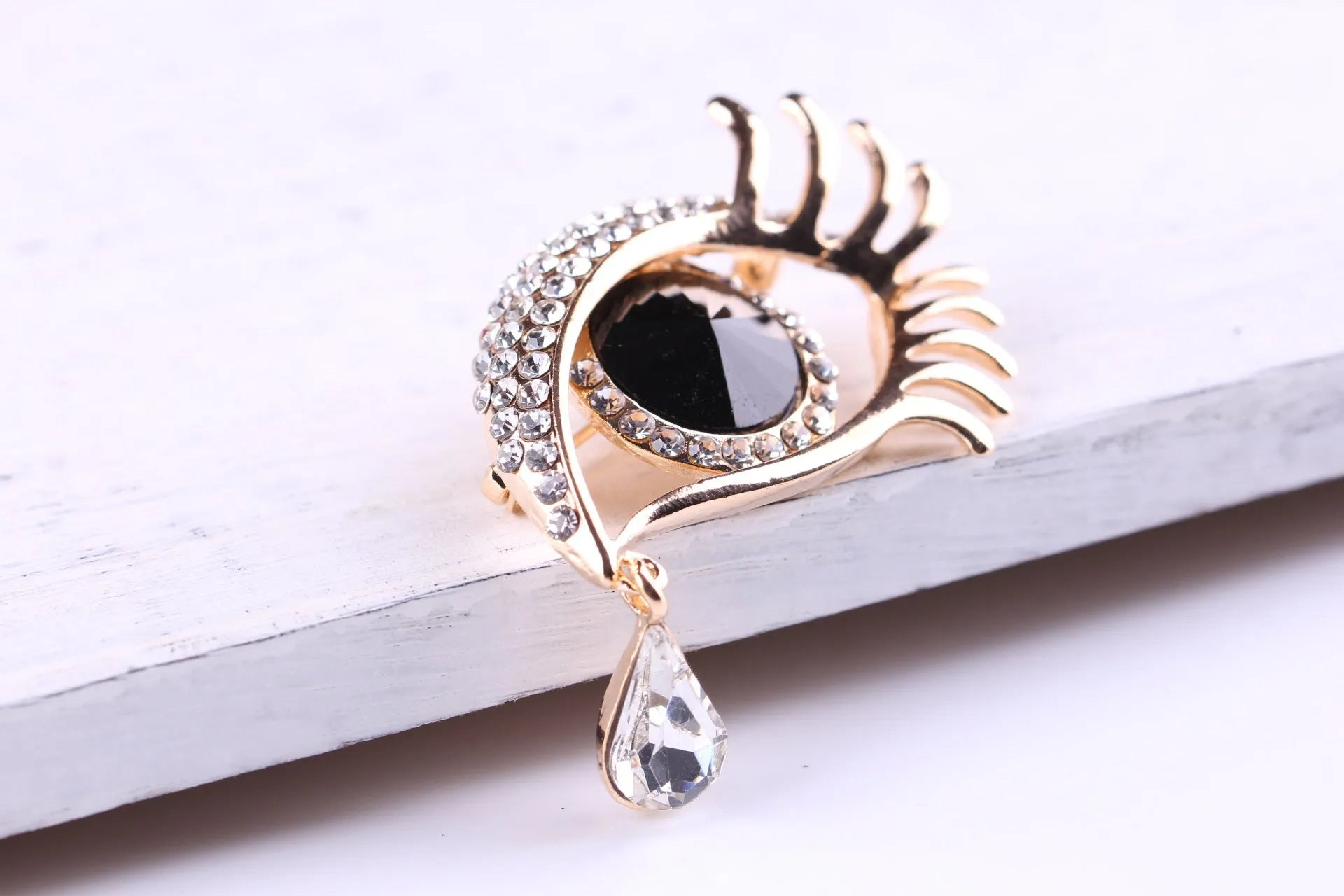 Teardrop rhinestone brooch pin alloy gold electroplated unisex totem style