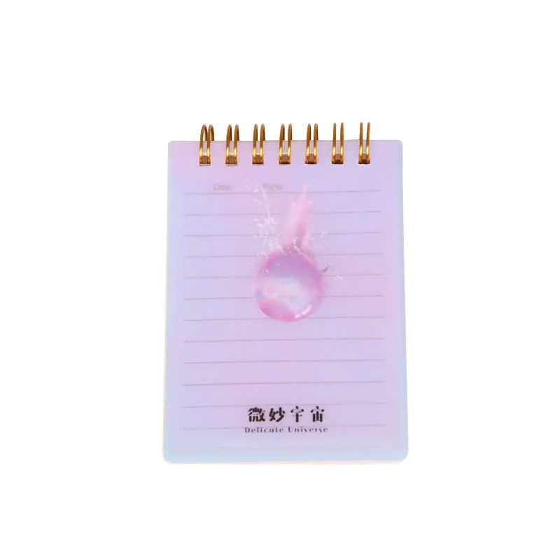 A7 rollover coil spiral notebook in four colours with spiral binding showing lay-flat pages