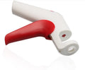 Manual cherry pitter tool with stainless steel coring mechanism on a kitchen worktop.