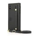 Black leather iPhone holster case with card slot in the back cover on a wooden table.