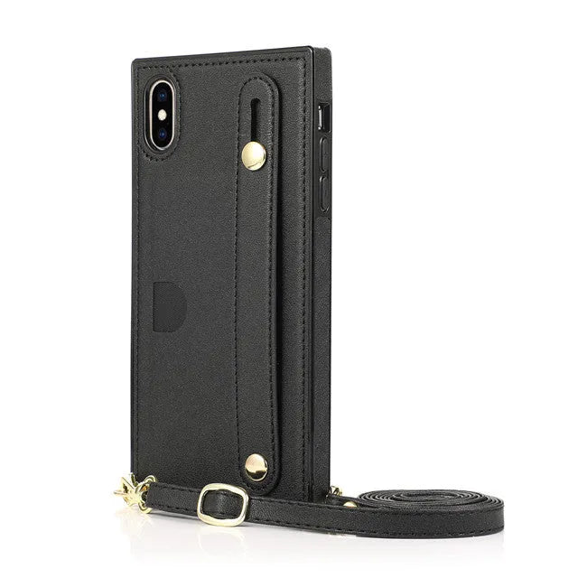 Black leather iPhone holster case with card slot in the back cover on a wooden table.