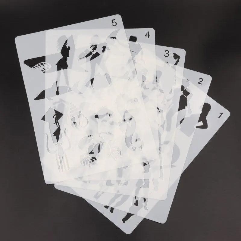 Set of white plastic drawing stencils with various cut-out design patterns