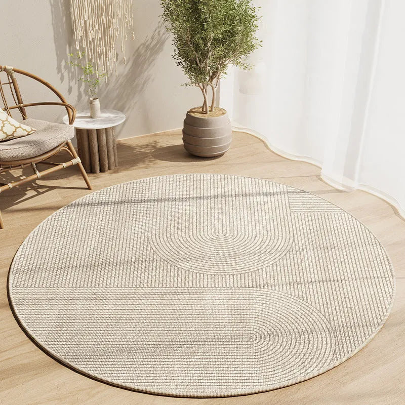 Simple round carpet in modern geometric pattern on floor under desk with swivel chair