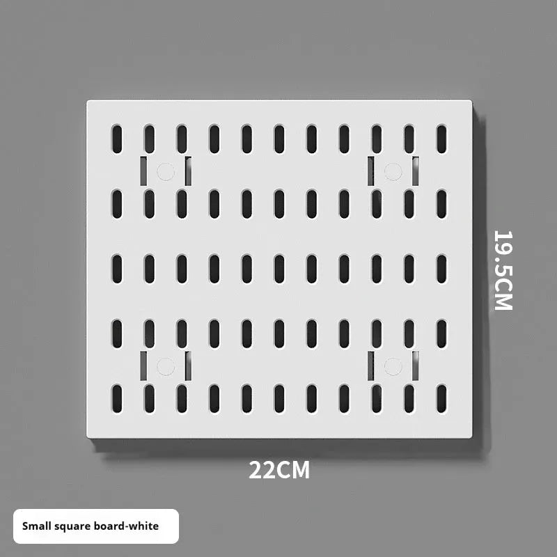 White punch-free wall board with wire-wrap loops holding cables and keys