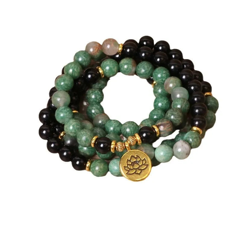 Green and black elastic beaded alloy bracelet showing stretch design and natural style