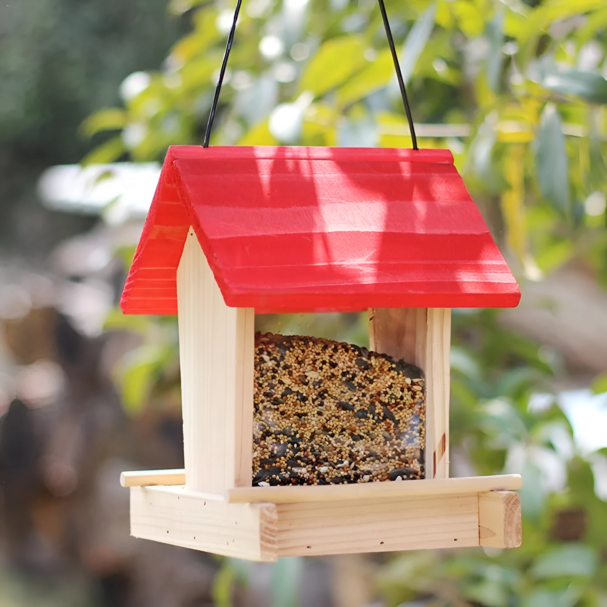 Suspended pine wood bird feeder with red roof and log texture finish