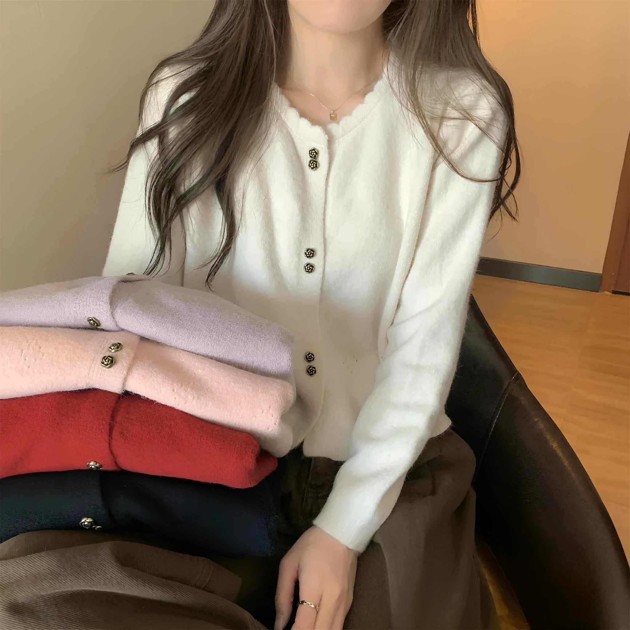 Women's long-sleeved acrylic cardigan coat in milky white, shown with a front opening.