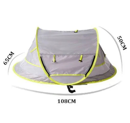 Grey children's beach tent with fiberglass frame and Oxford cloth outer, set up on sand