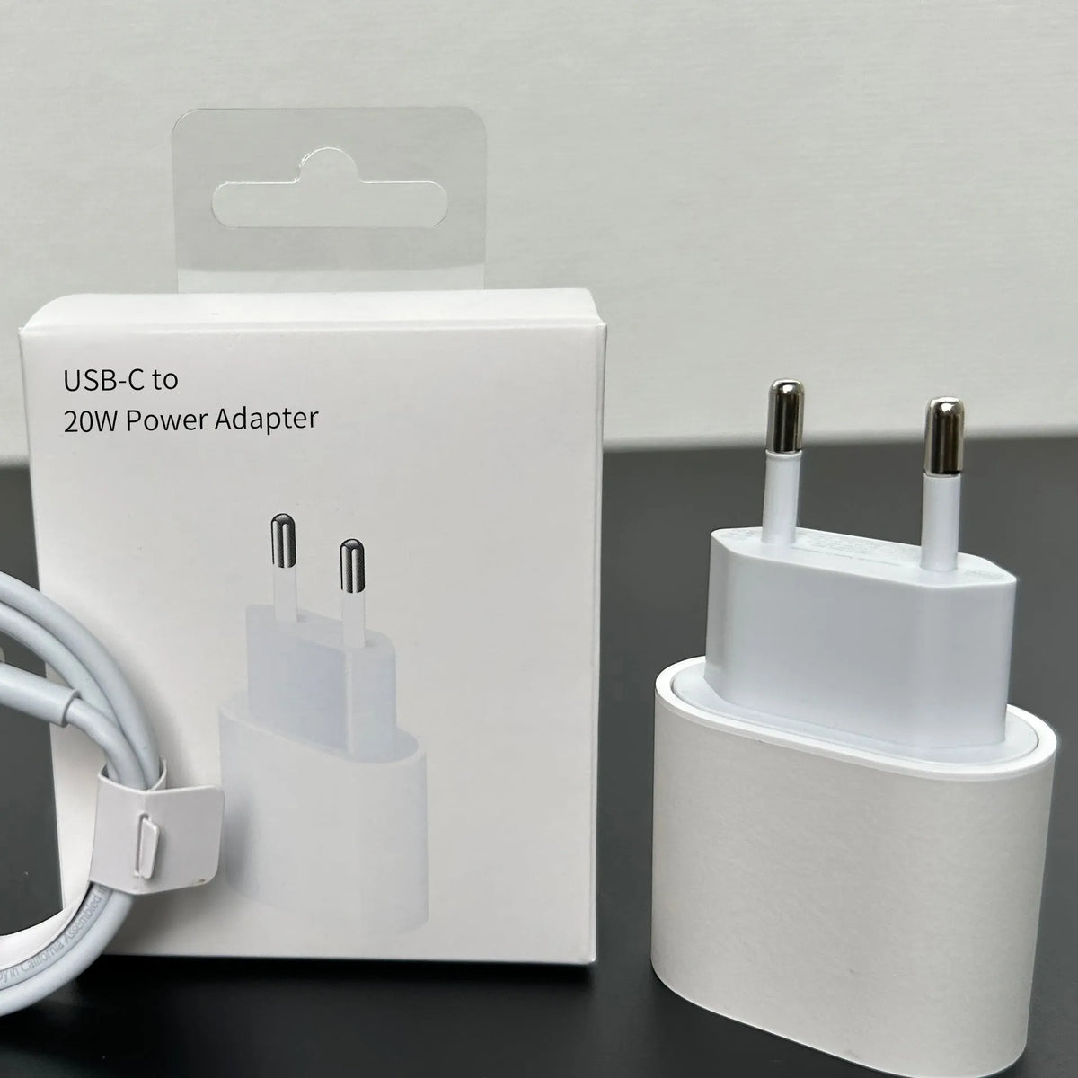 White 20W USB-C PD wall charger with UK three-pin plug.