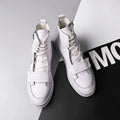 Men's black PU leather high-top winter ankle boots on a white background, showing sneaker-style design.