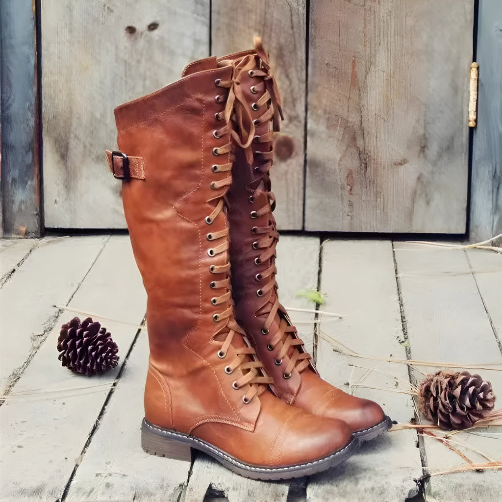 Women's black chunky heel high leg boot with a round toe and rubber sole.
