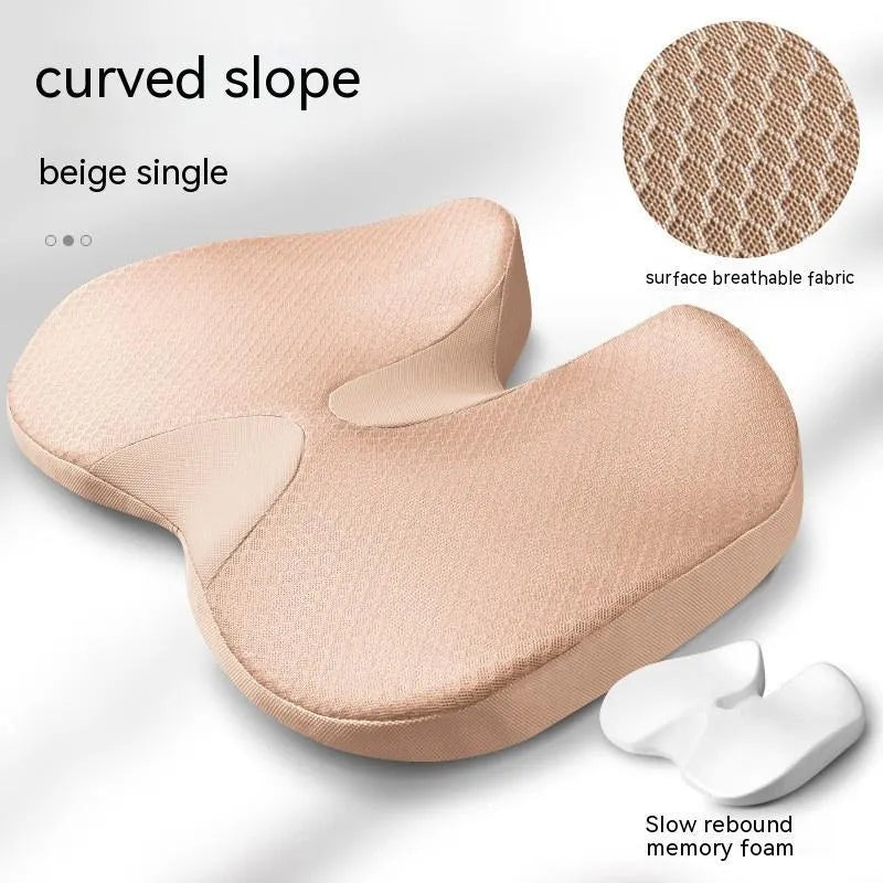 Curved bevel seat cushion in beige colour on a car seat, designed for tailbone support.