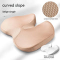 Curved bevel seat cushion in beige colour on a car seat, designed for tailbone support.