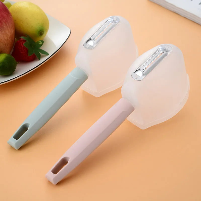 Stainless steel fruit peeler with PP handle, shown in pink or blue, modern minimalist kitchen gadget for fruit peeling