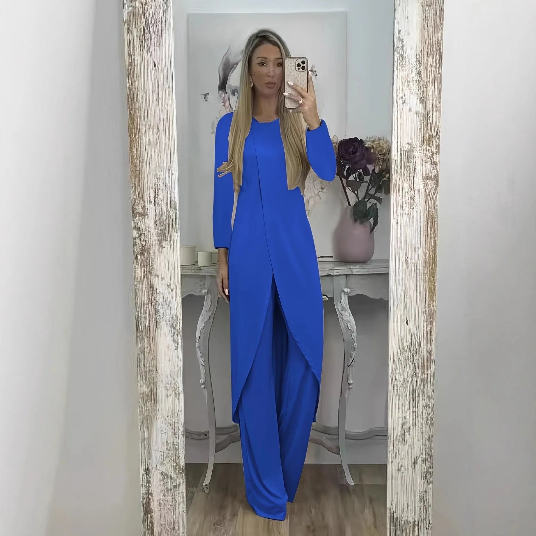 A loose-fitting black two-piece lounge set consisting of a long-sleeve round-neck top and matching trousers.