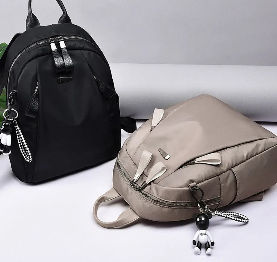 Medium-sized Oxford cloth rucksack in grey with double shoulder straps and a top handle.