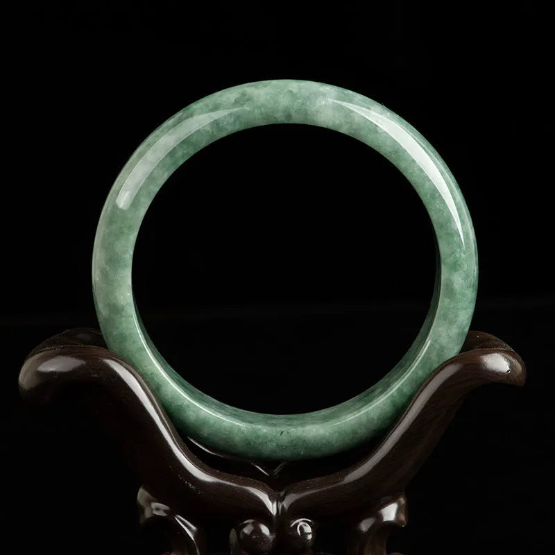 Natural emerald bean green simple solid bracelet on a gift box, showing dark pea green colour.