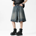 Retro blue washed denim shorts for men with a splash ink pattern and ripped detailing on the legs.