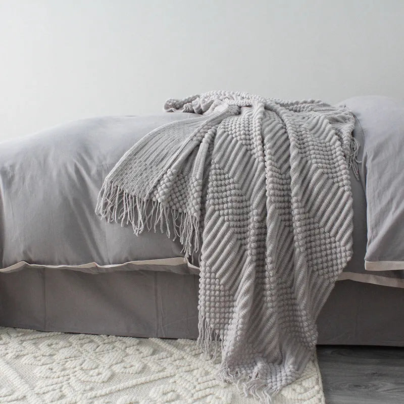 Small light grey polyester nap blanket laid flat showing 127x170cm size.