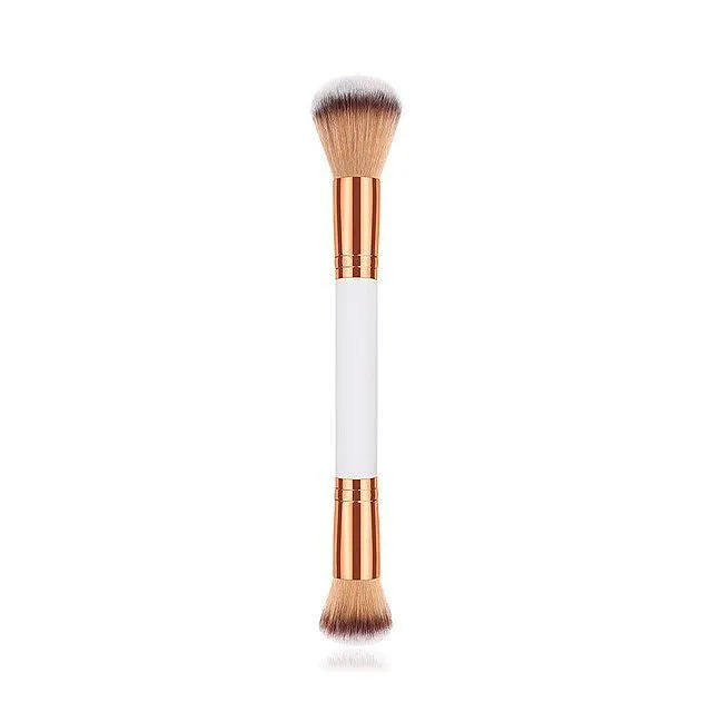White double head makeup brush with wooden handle and nylon wool bristles on flat surface