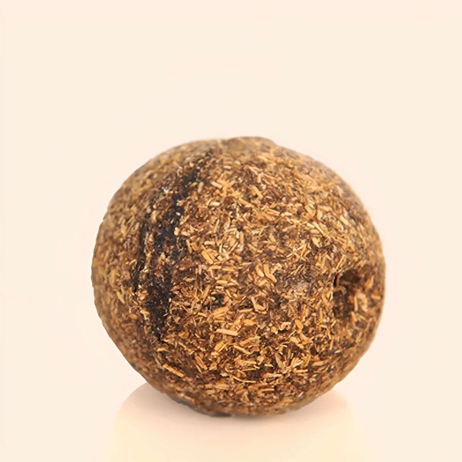 Natural catnip treat ball for cats, with catnip scent inside, on a neutral background