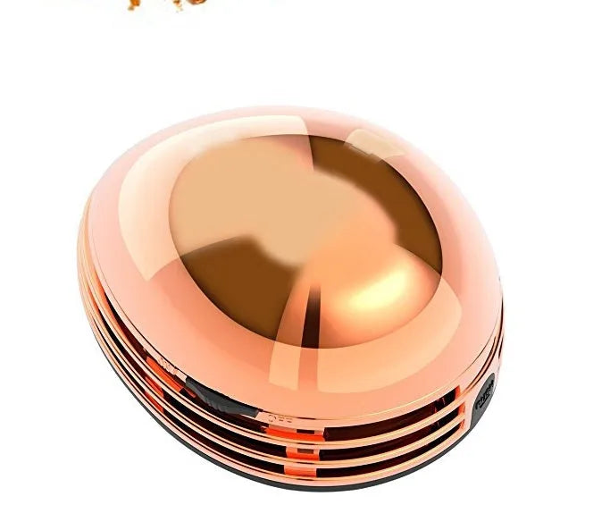 Gold portable mini desktop vacuum cleaner 18x12x10 cm on a wooden desk
