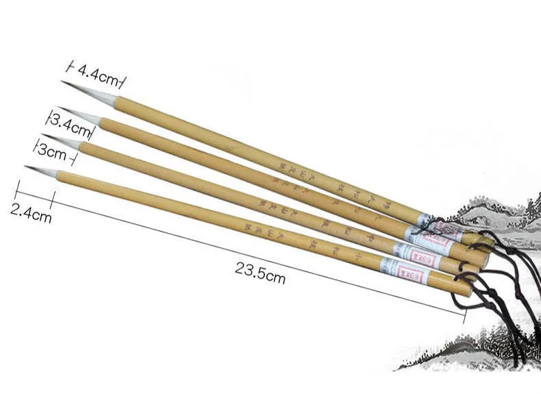 Set of four gold-handled writing brushes with mixed hair bristles for calligraphy.