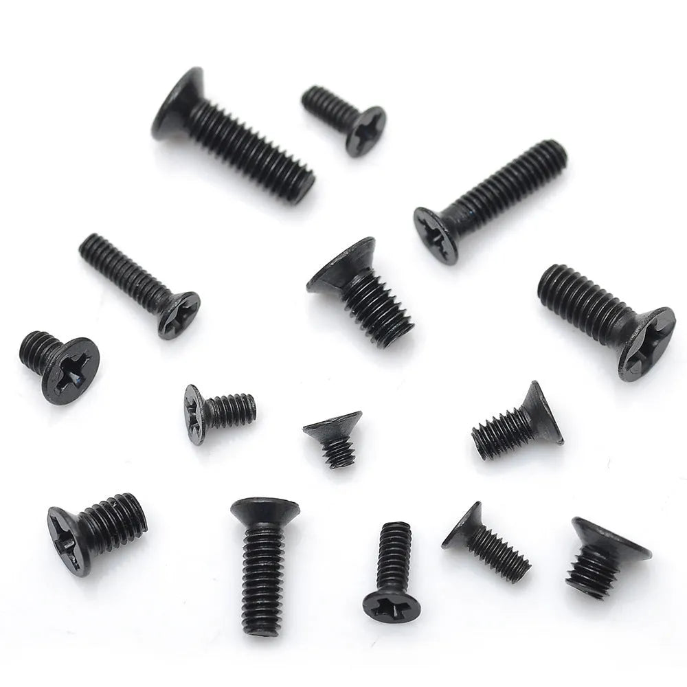 Black plated flat head laptop machine screws with Phillips drive, shown loose and in a box.