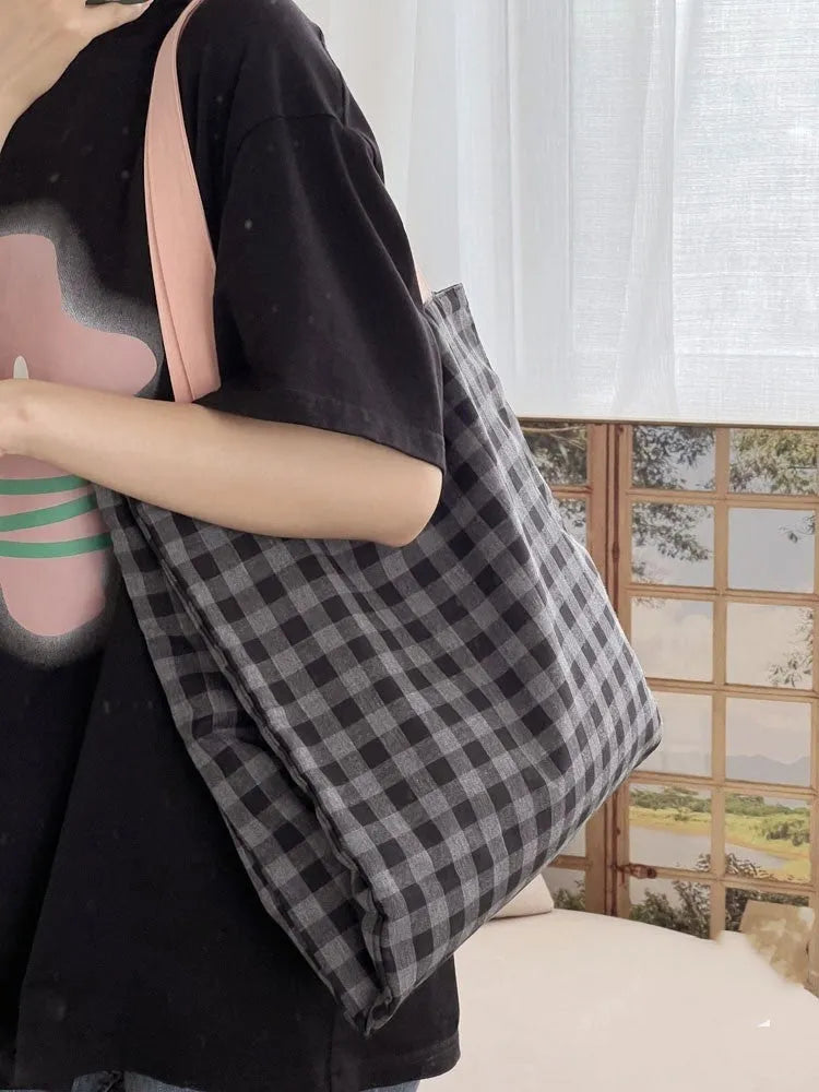 Casual multi-layer canvas tote shoulder bag in a plaid pattern with a wide strap.