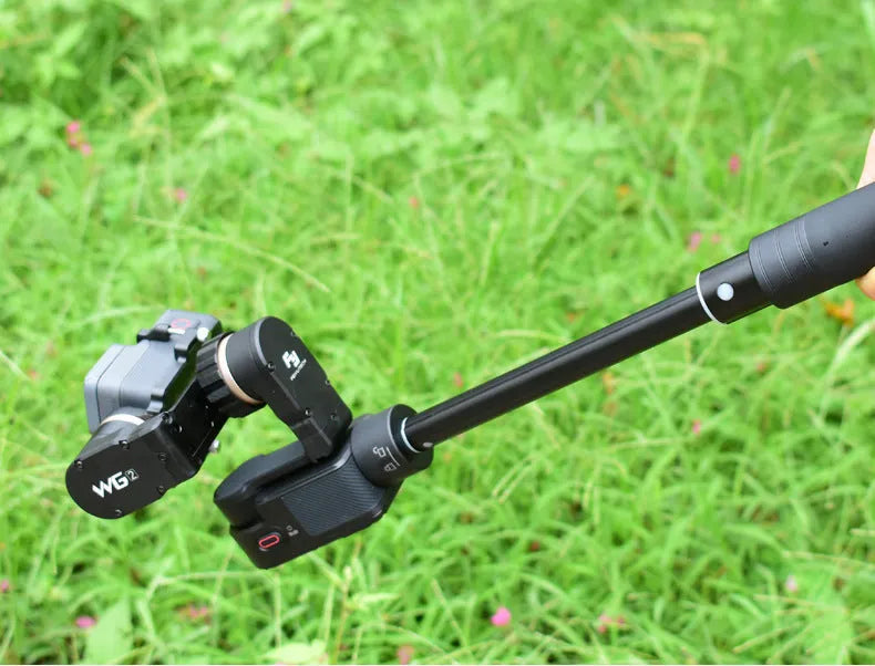 Black retractable selfie stick with handheld stabilizer grip extended for smartphone photography