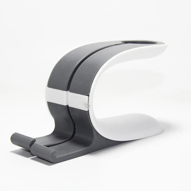 Grey Apple Watch and iPhone charging stand on a wooden desktop