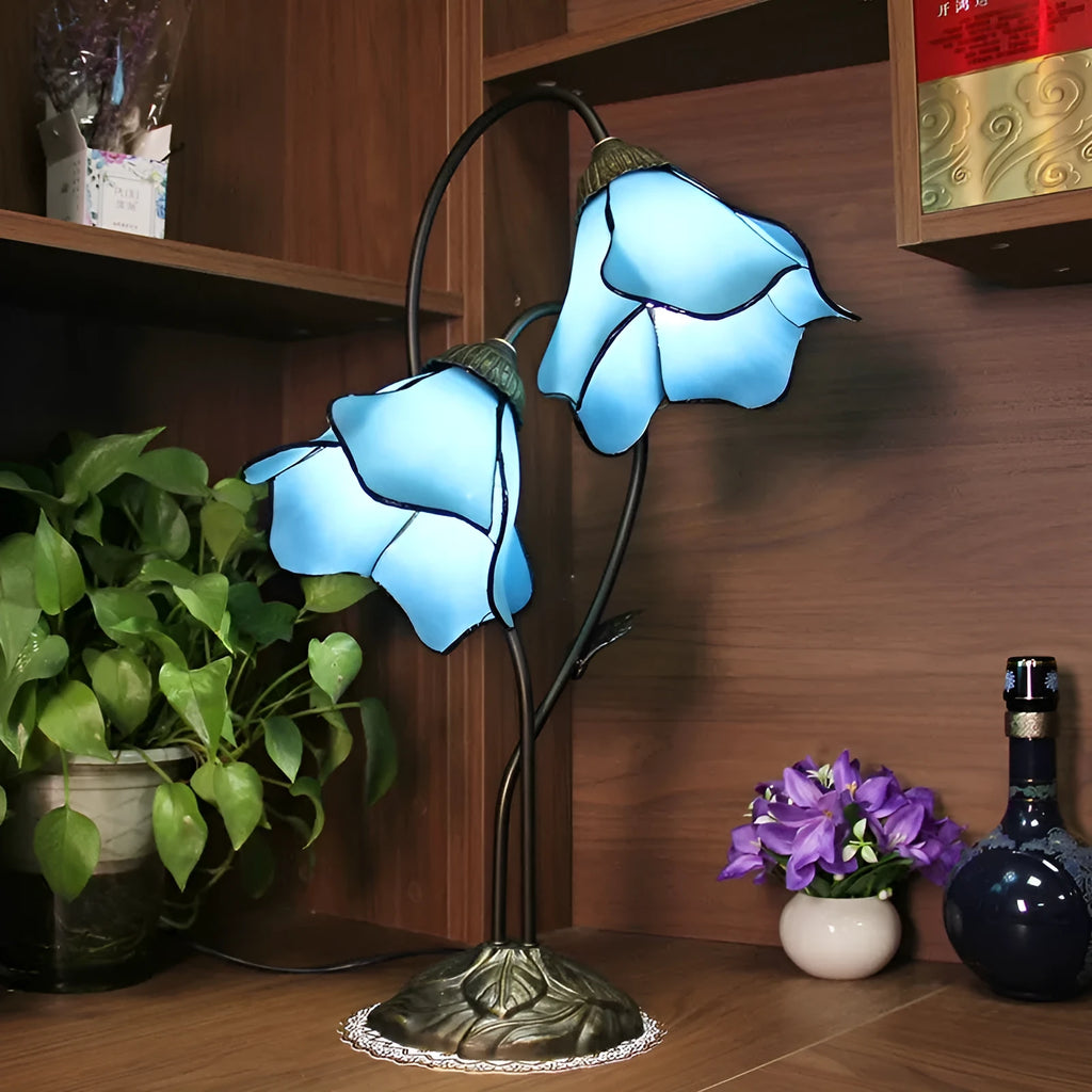 Retro American style desk lamp with lotus glass shade on wooden table.