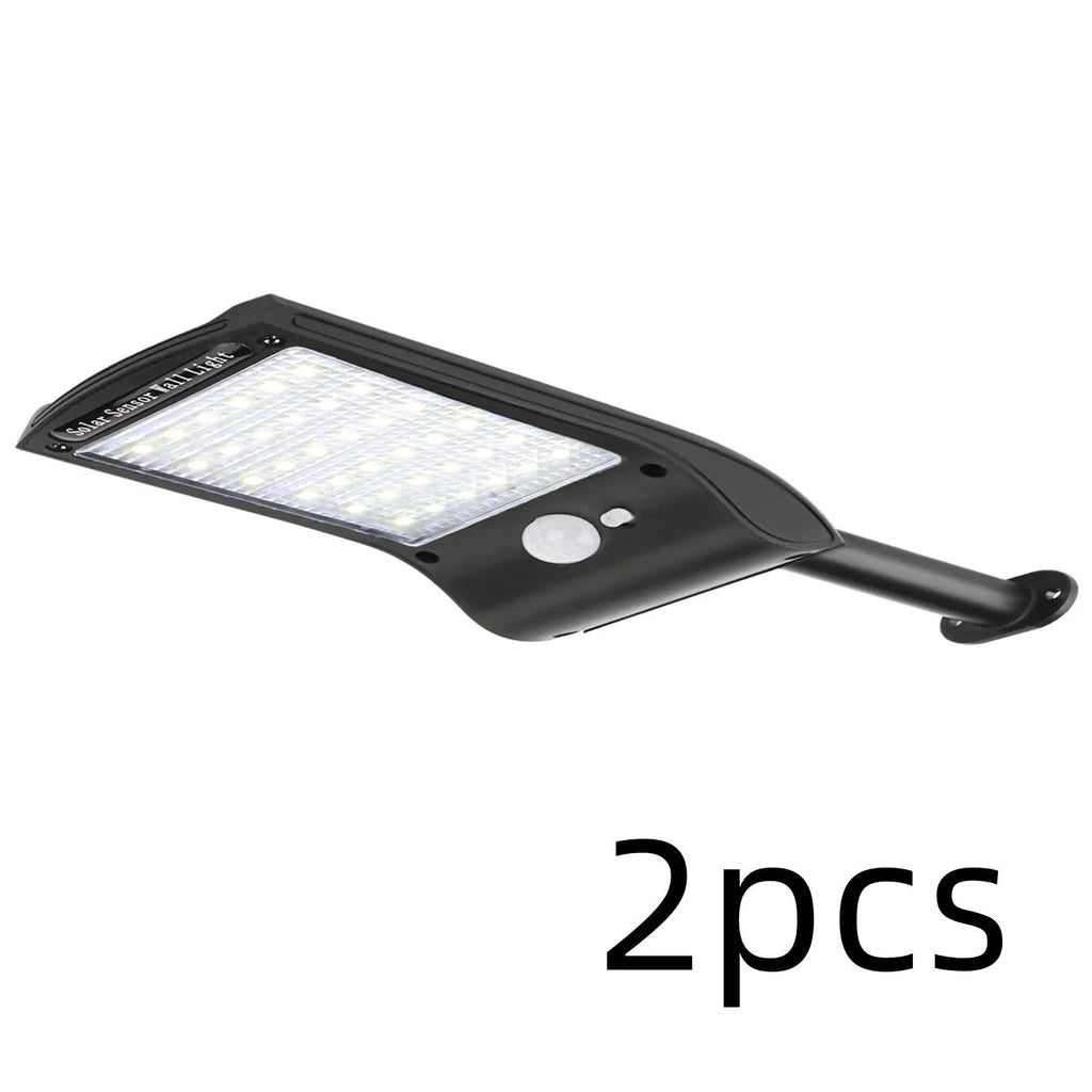 Black solar-powered outdoor wall light with motion sensor and 36 LEDs on an adjustable mount.