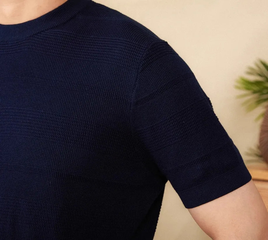Men's off-white pure cotton short sleeve T-shirt with a round neck on a hanger.