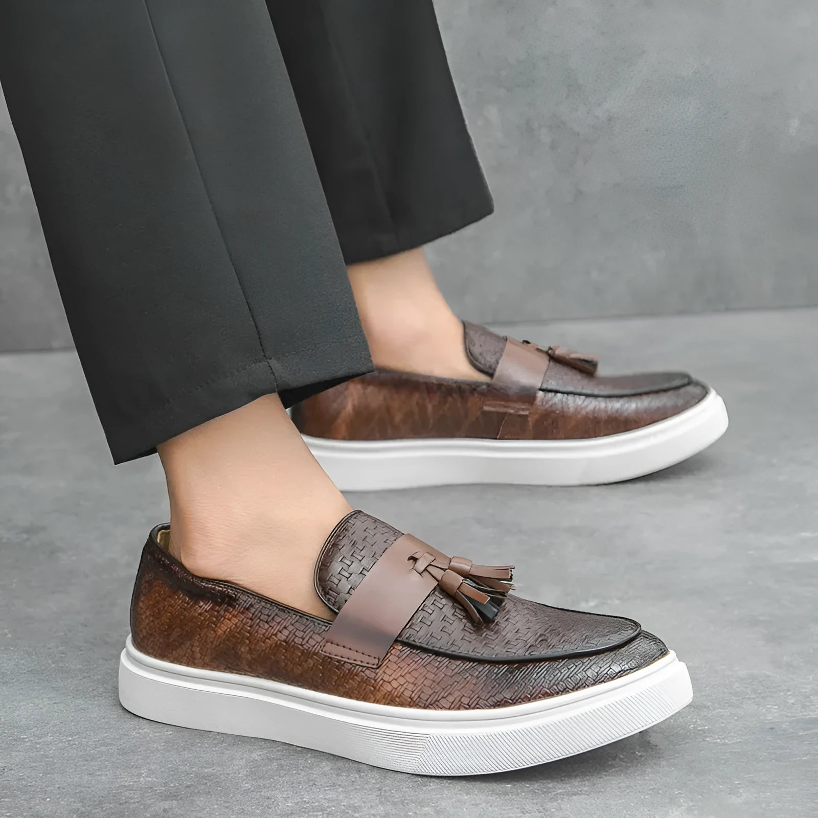 Men's black casual fringed leather shoes with a low heel and round toe on a white background.