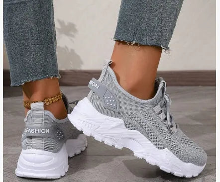 Women's Flyknit mesh casual sports shoes in various colours with flat heel and lace-up front.
