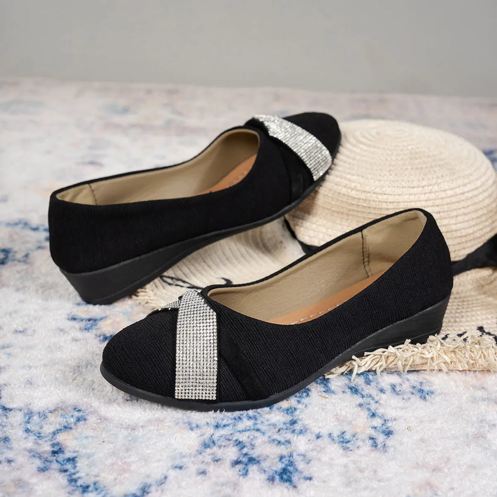 Black women's slip-on casual shoes with rhinestone detail on fabric upper and a short chunky heel.