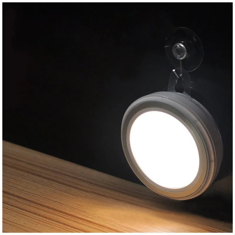 Circular white motion sensor LED light unit showing 80mm diameter on a table.