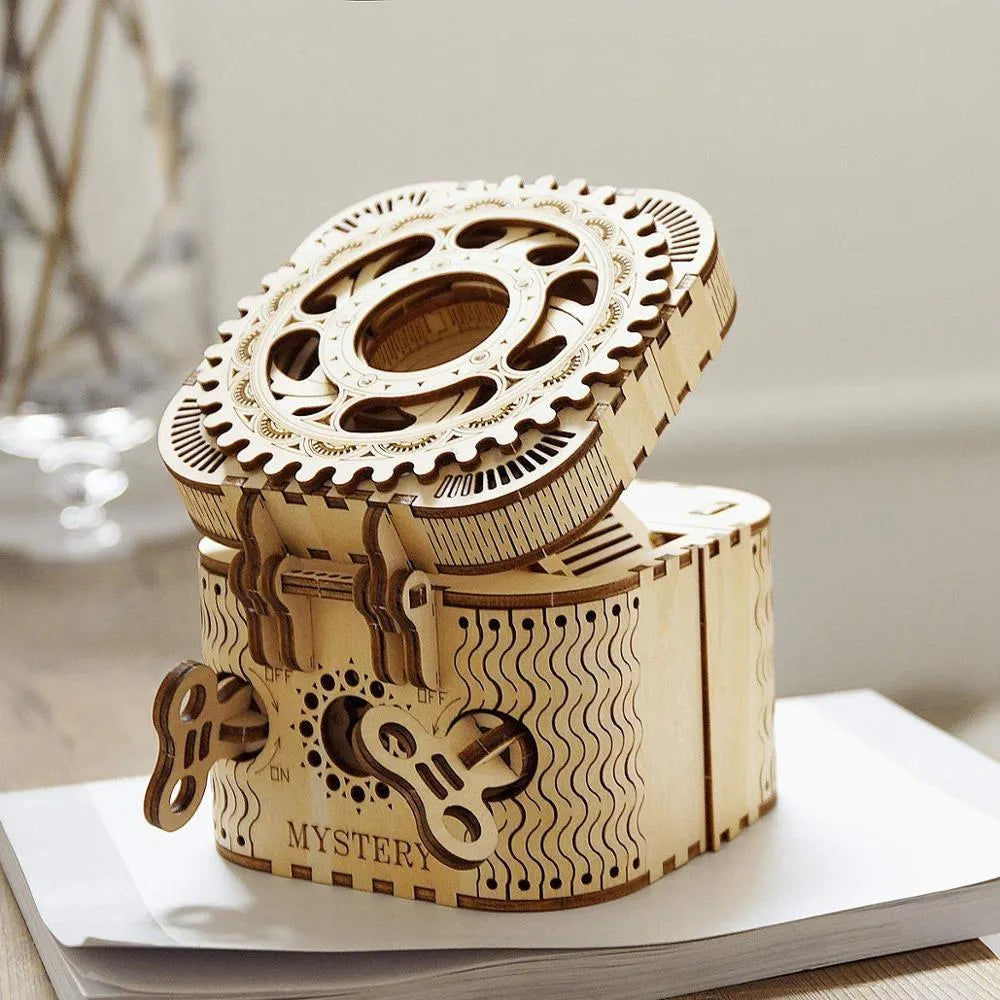 Flat-packed wooden 3D puzzle film projector with visible gear wheel assembly and hand crank