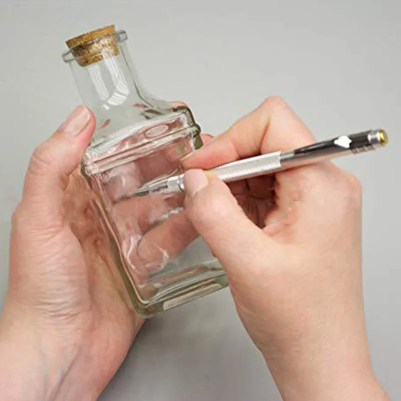 Silver aluminum glass marking pen with tungsten carbide tip on white background
