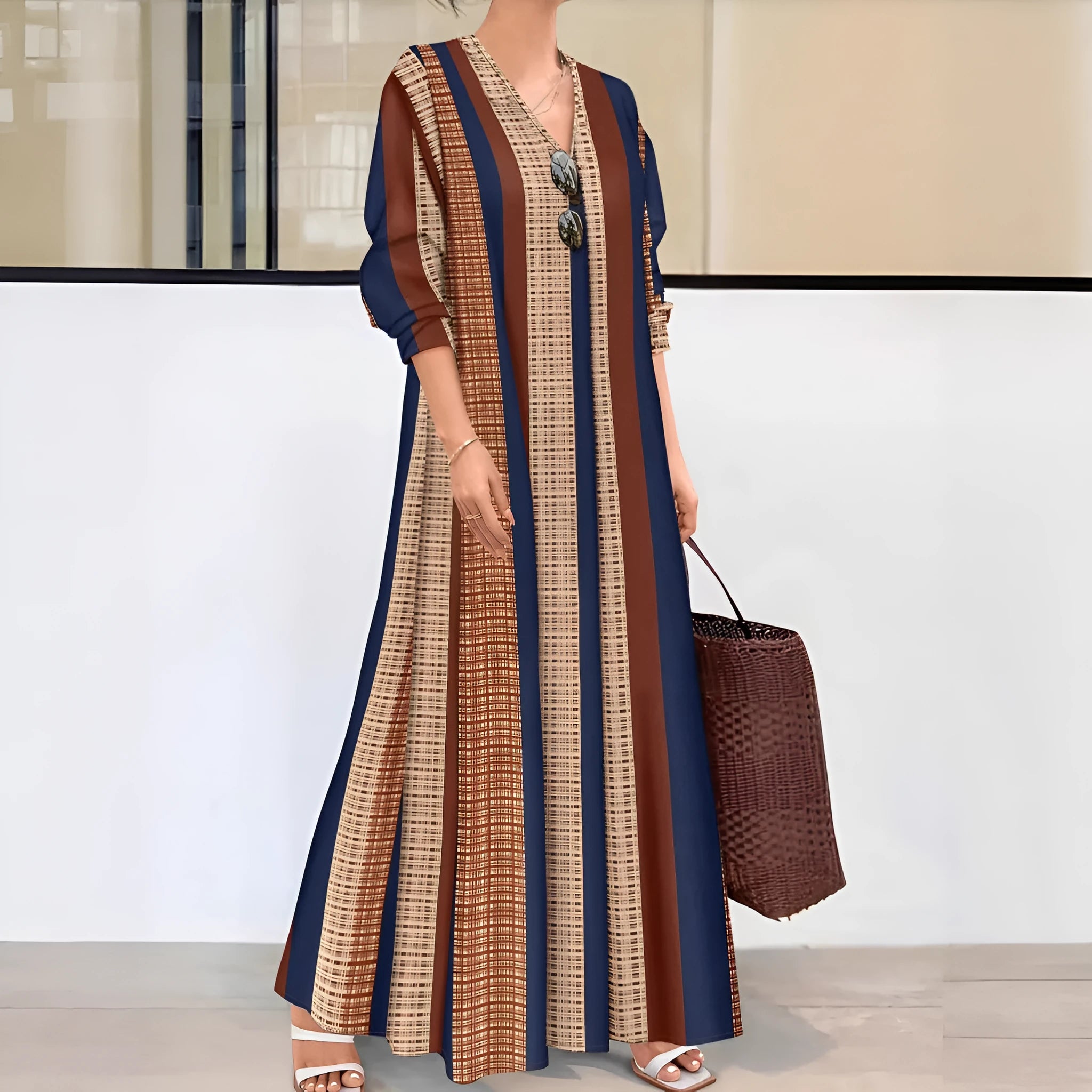 Camel coloured women's dress with vertical stripes, V-neckline, and A-line skirt