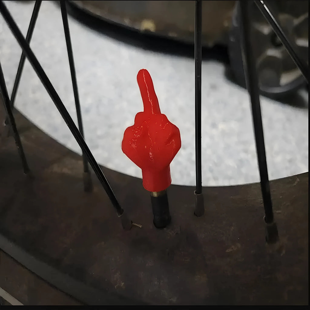 Four latex tyre valve caps shown in skin colour and black colours for dust protection