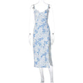 Women's blue lace flower print long dress with a thigh slit and thin suspender straps.