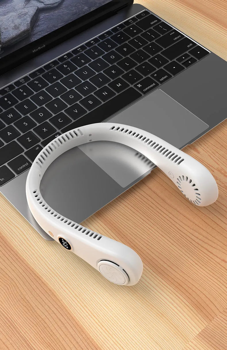 Pink bladeless neck fan worn around neck with USB charging cable