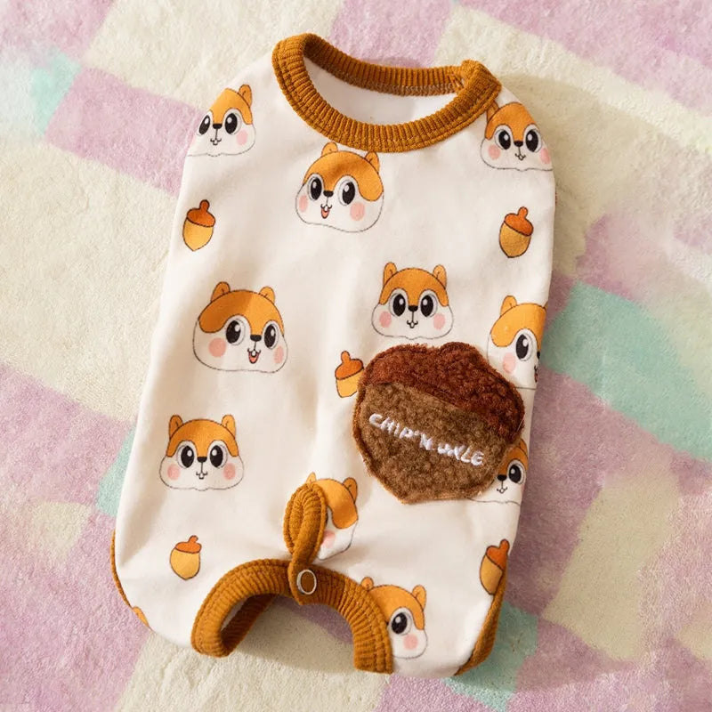 Chip 'n' Dale sleeveless dog jumpsuit with squirrel and acorn print, fuzzy embroidered acorn pocket, ribbed cuffs and snap closure, cream or white.