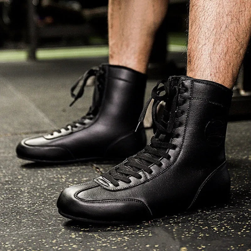 Professional black and gold mesh boxing shoe for indoor wrestling and training.