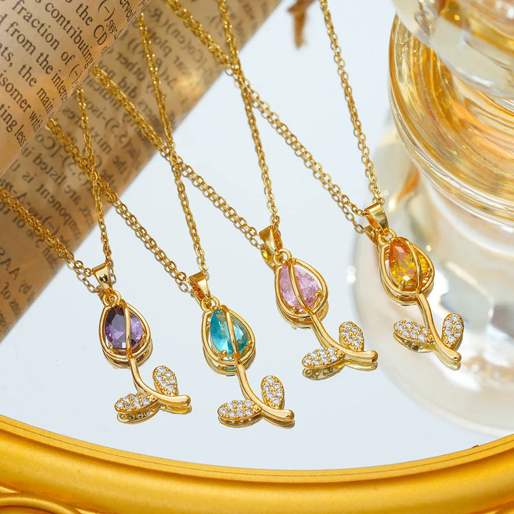 Gold-coloured tulip flower necklace on an adjustable O‑ring chain, shown in one of five colour options.