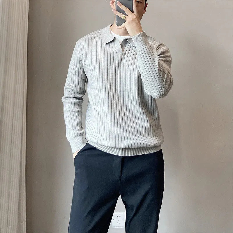 Men's loose grey knitted pullover sweater with long sleeves on a hanger.
