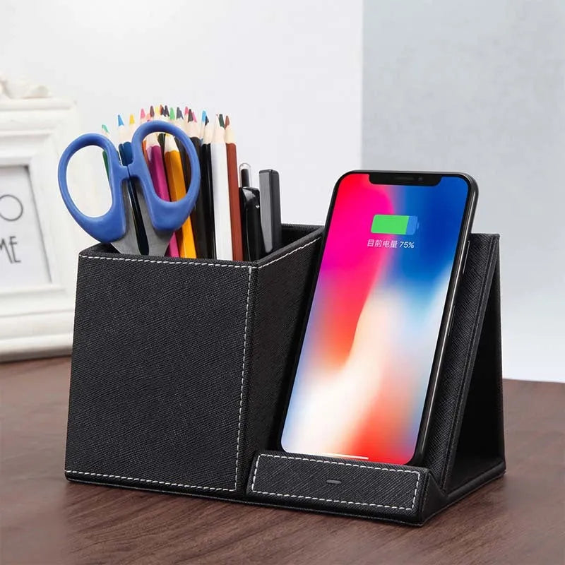 Black leather wireless charging station with phone on stand and pens in holder